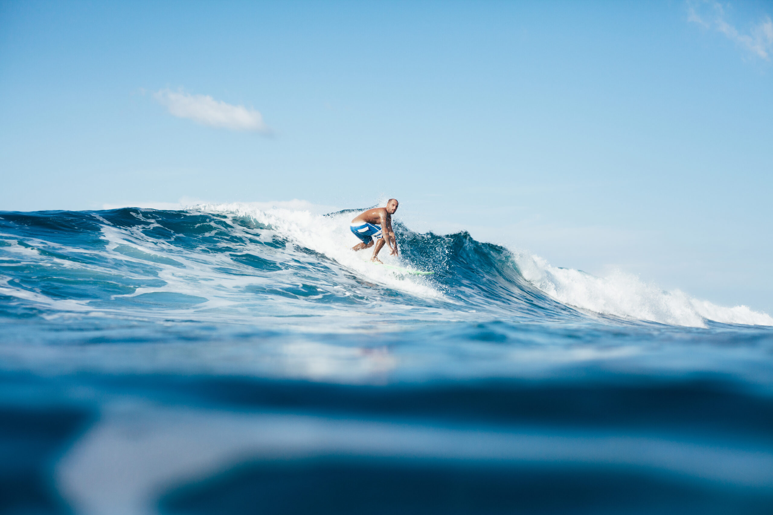 handsome young man surfing on sunny day